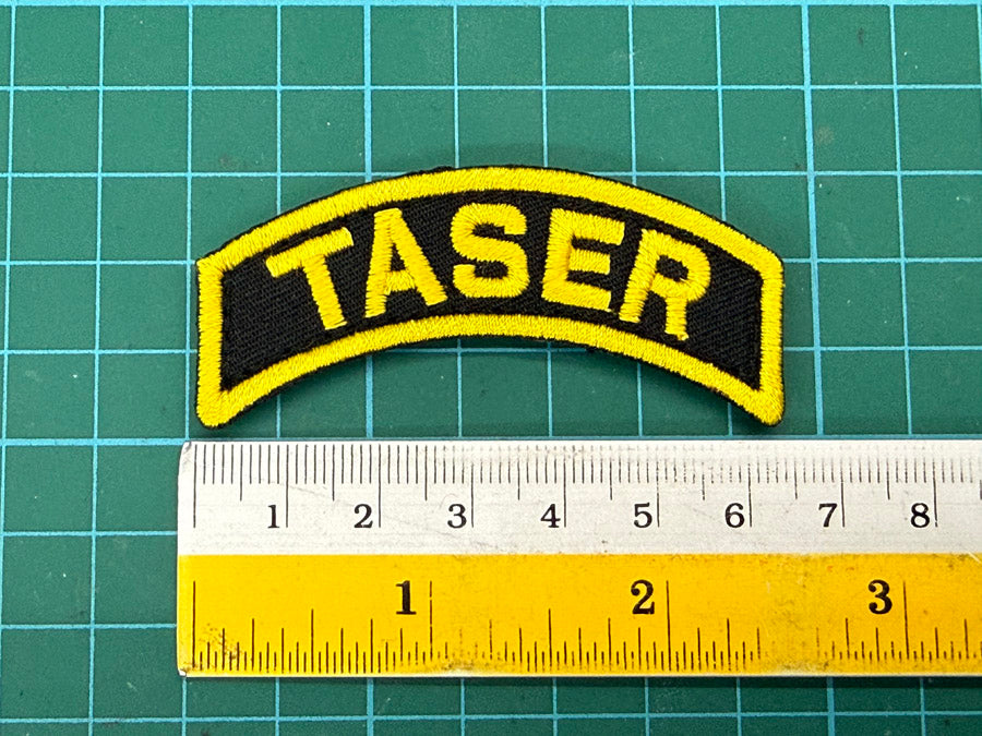 SPF Taser Velcro Tab - 6.5 cm (Black Cloth with Yellow Wording)